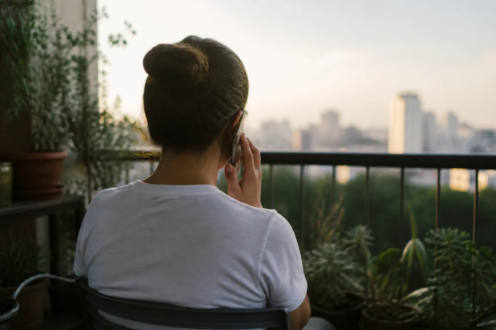 Person on a balcony taking a phone call